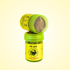 Yellow herbal inhaler with green cap on a light yellow background